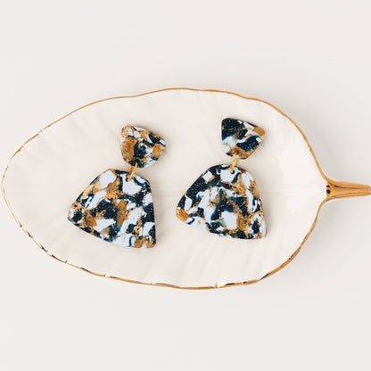 Sculpey Premo Clay Black 1lb with marbled black, gold, and white clay earrings on wooden palette