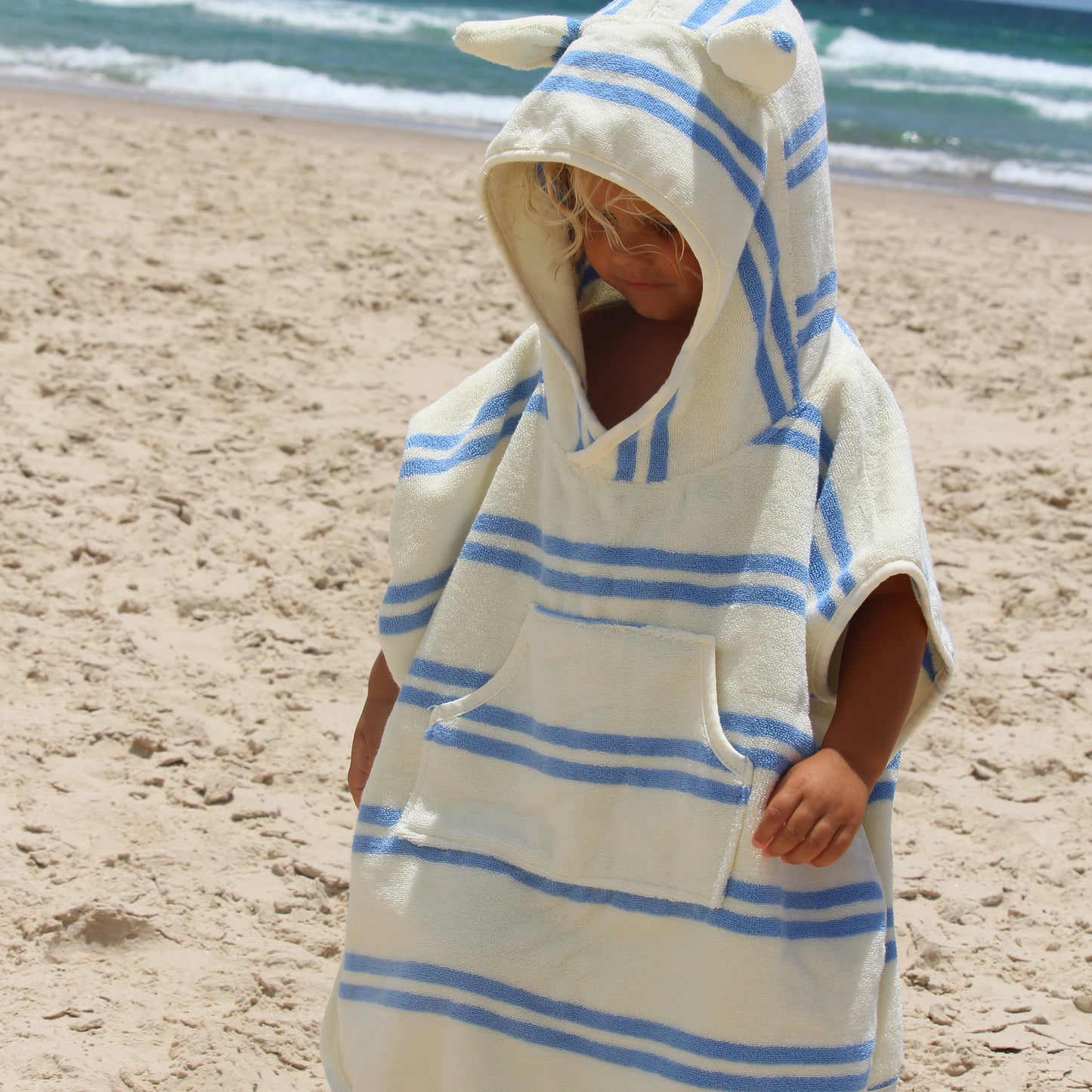 Sammy the Seagull blue striped hooded towel worn by child at beach