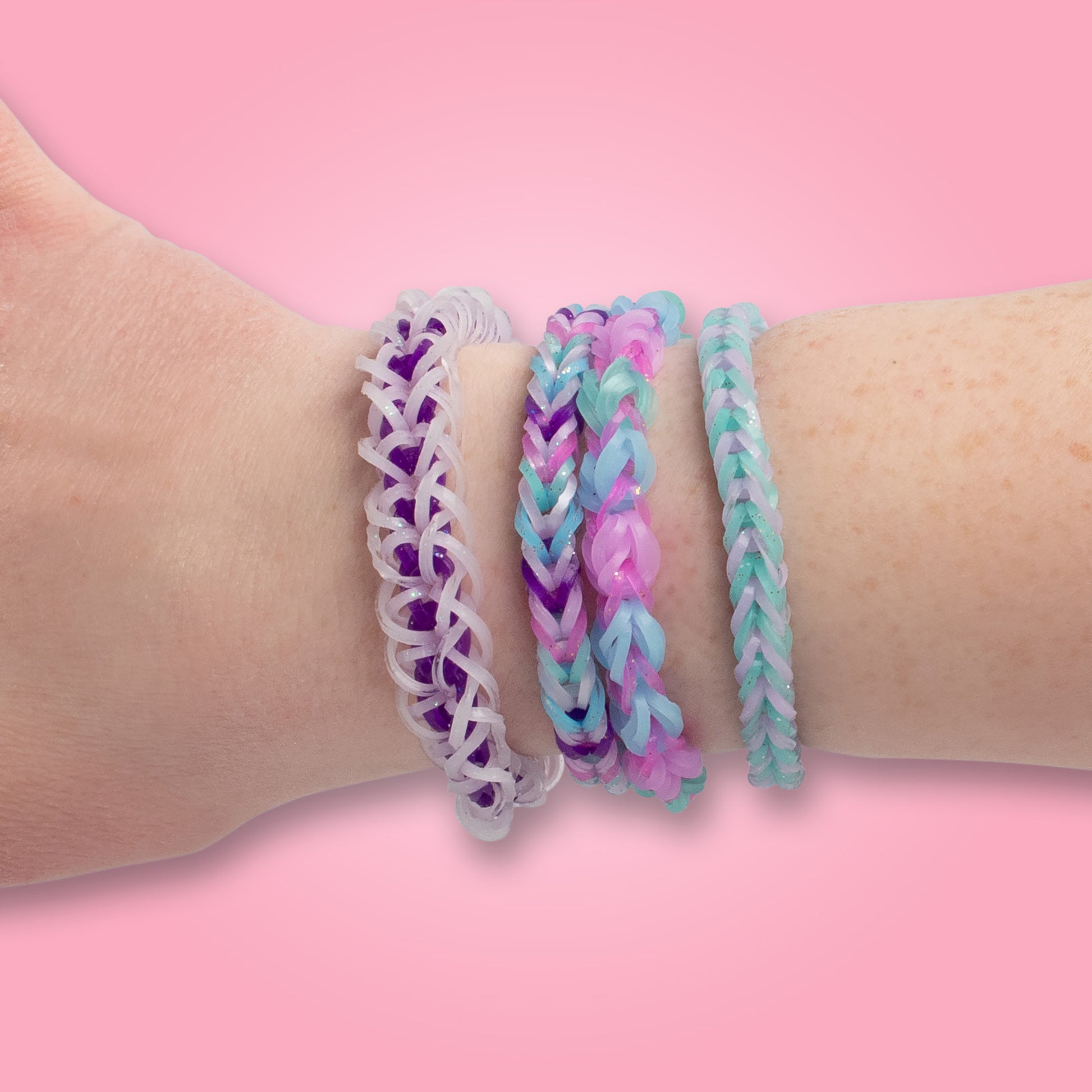 Rainbow Loom Sparkle Pop bracelets in purple, pink, and turquoise chevron patterns