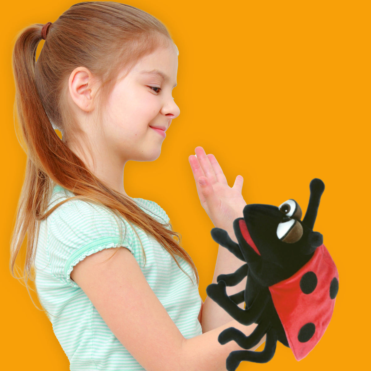 Living Puppets Trudy The Ladybug hand puppet with red and black body held by child