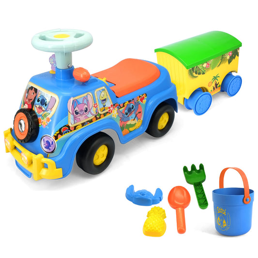 Blue ride-on vehicle with Stitch character graphics, orange seat, steering wheel, and detached yellow cargo trailer. Includes accessories: blue crab toy, yellow