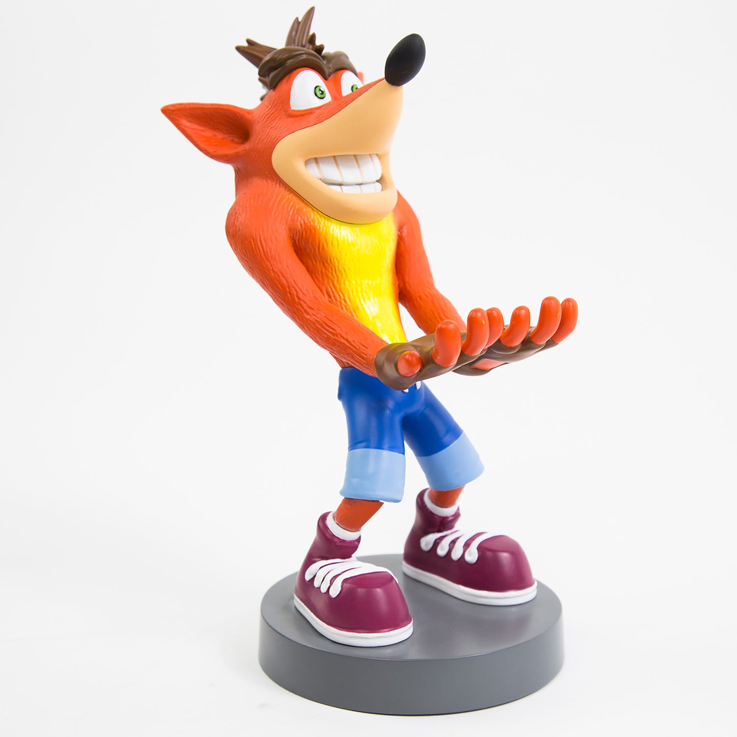 Crash Bandicoot Trilogy Cable Guys phone holder figure with orange fur, yellow shirt, blue shorts