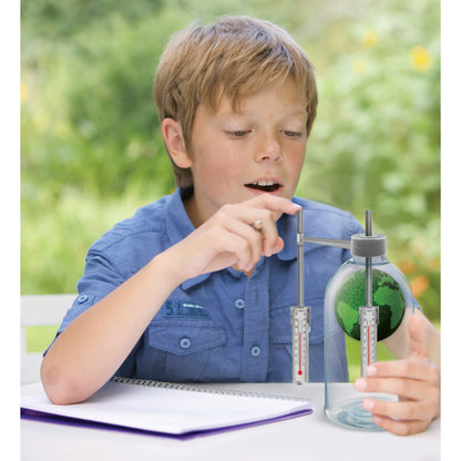 Green Science Weather Science kit with boy observing green moss sphere and thermometer