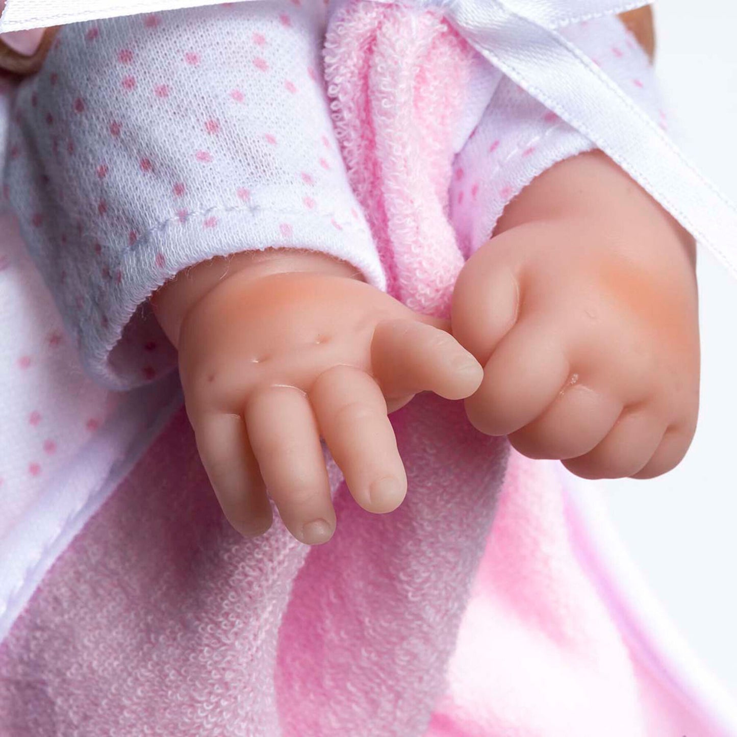 JC Toys La Baby 11 inch soft body doll with caucasian features wearing white and pink outfit