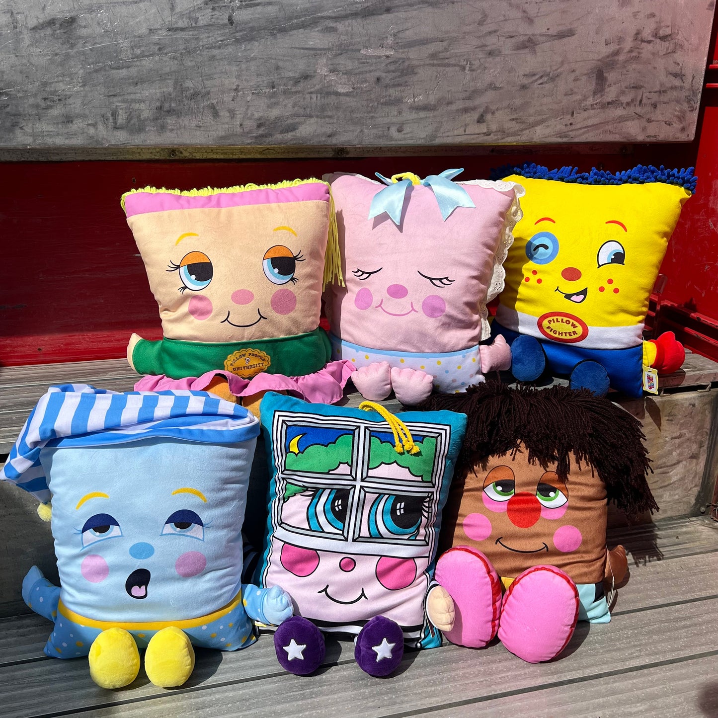 Pillow People PJ Sandman plush toys and pillows in colorful designs including yellow, pink, and blue characters