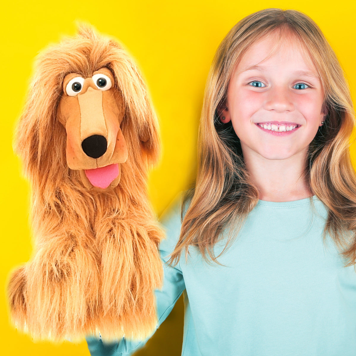 Living Puppets Honey Pup hand puppet with golden-tan coloring next to smiling child in light blue shirt