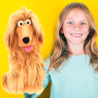 Living Puppets Honey Pup hand puppet with golden-tan coloring next to smiling child in light blue shirt