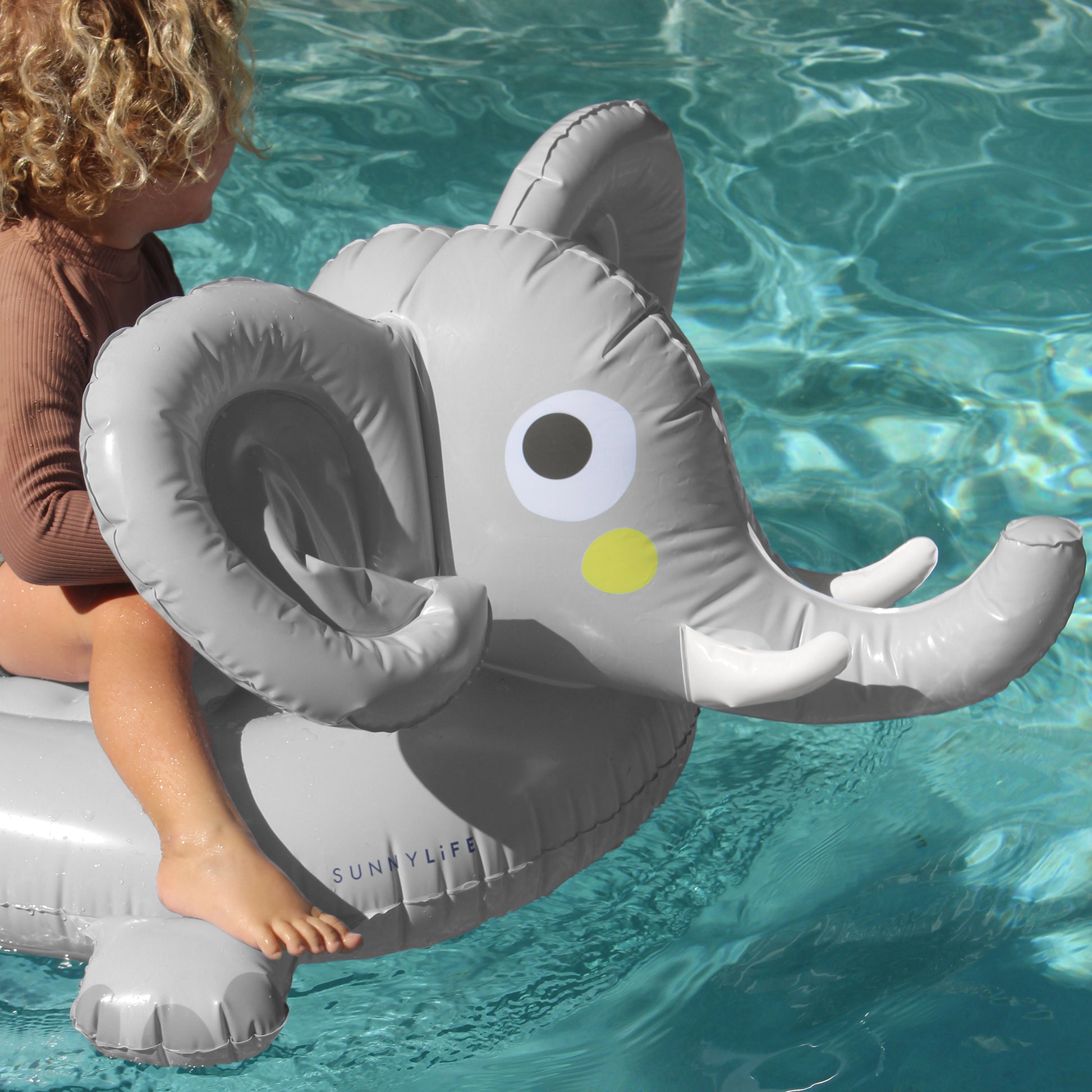 Sunnylife Eli The Elephant gray and white inflatable pool float with handles in swimming pool