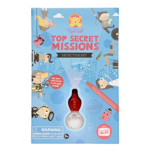 Tiger Tribe Top Secret Missions Detective Set box featuring spy-themed illustrations, lion logo, and red magnifying glass torch attachment on blue background