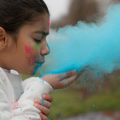 Holi Color Powder 20 Pack with vibrant blue, pink, and green powder being blown