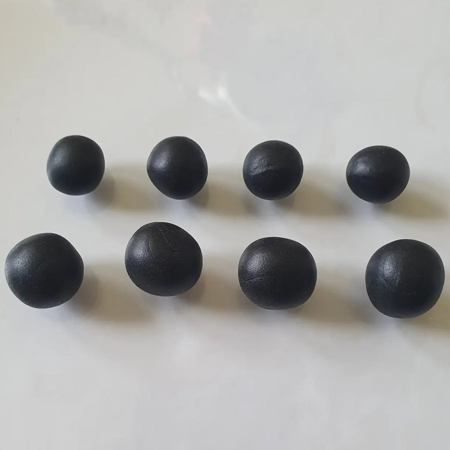 Sculpey Premo Clay Black 1lb - Eight dark black clay balls displayed