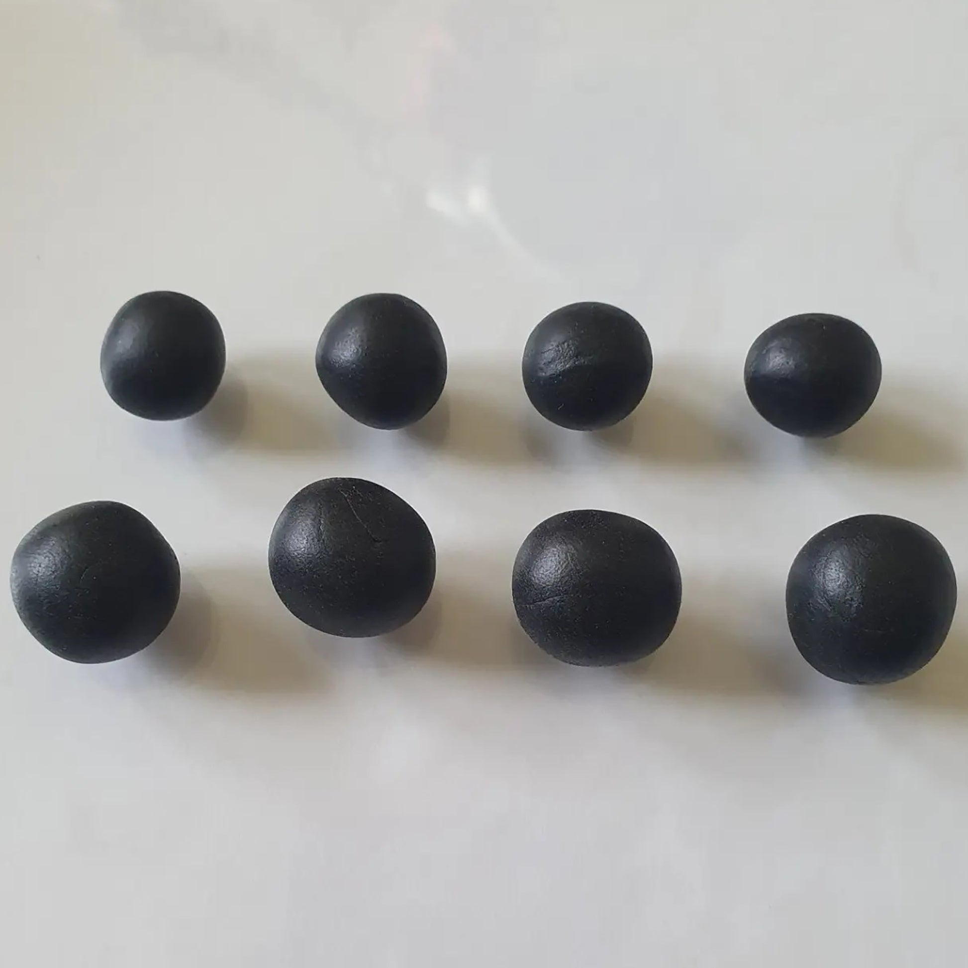 Sculpey Premo Clay Black 1lb - Eight dark black clay balls displayed