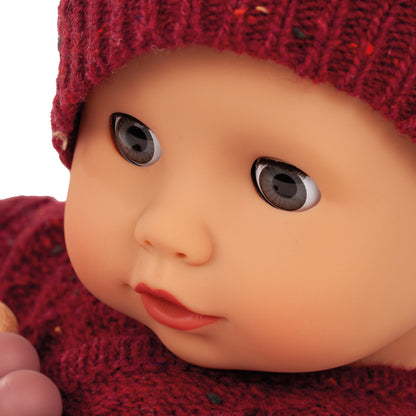 Jubilee Muffin Baby 13 inch soft doll wearing burgundy knit hat and outfit