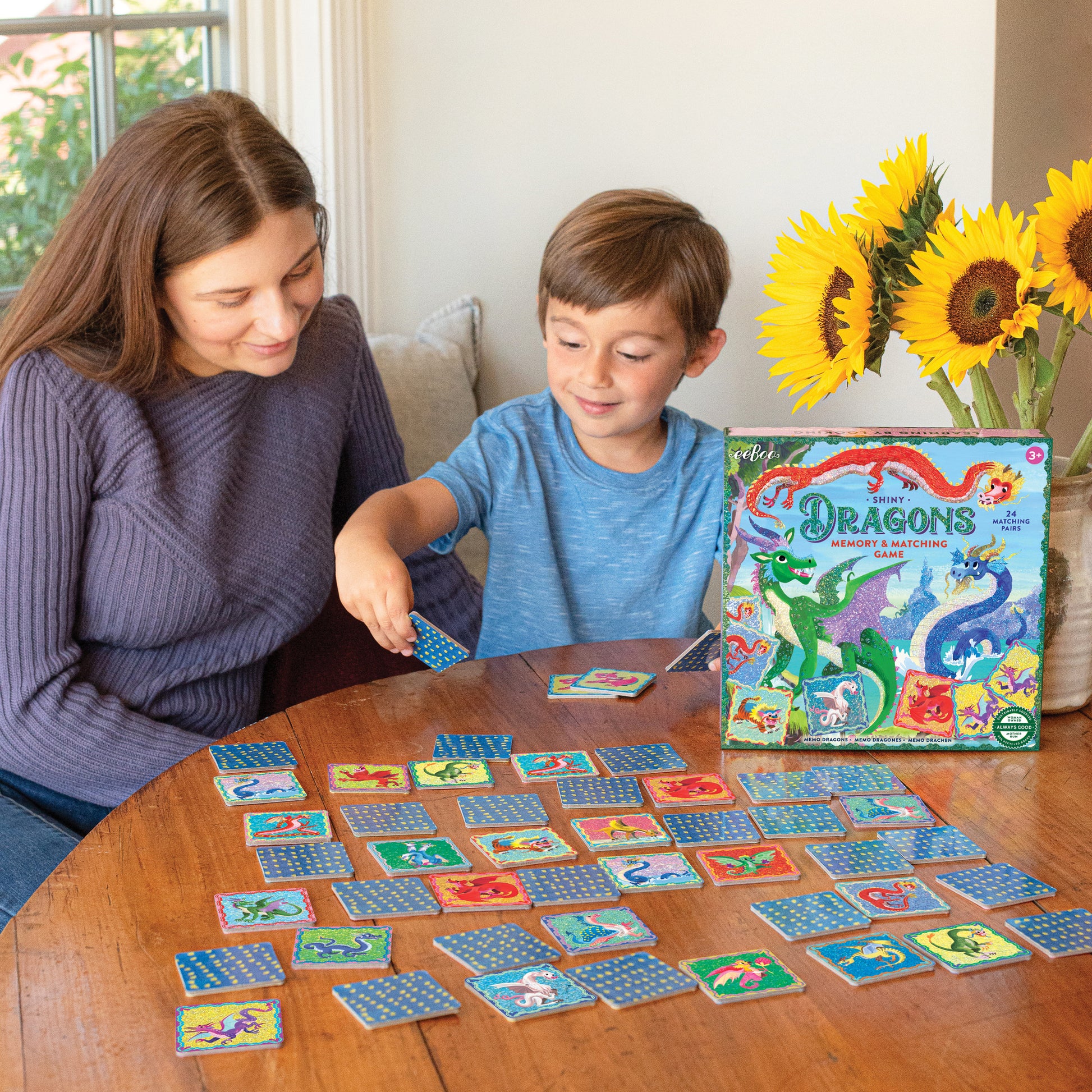 Shiny Dragons Memory & Matching Game with colorful dragon cards being played by adult and child