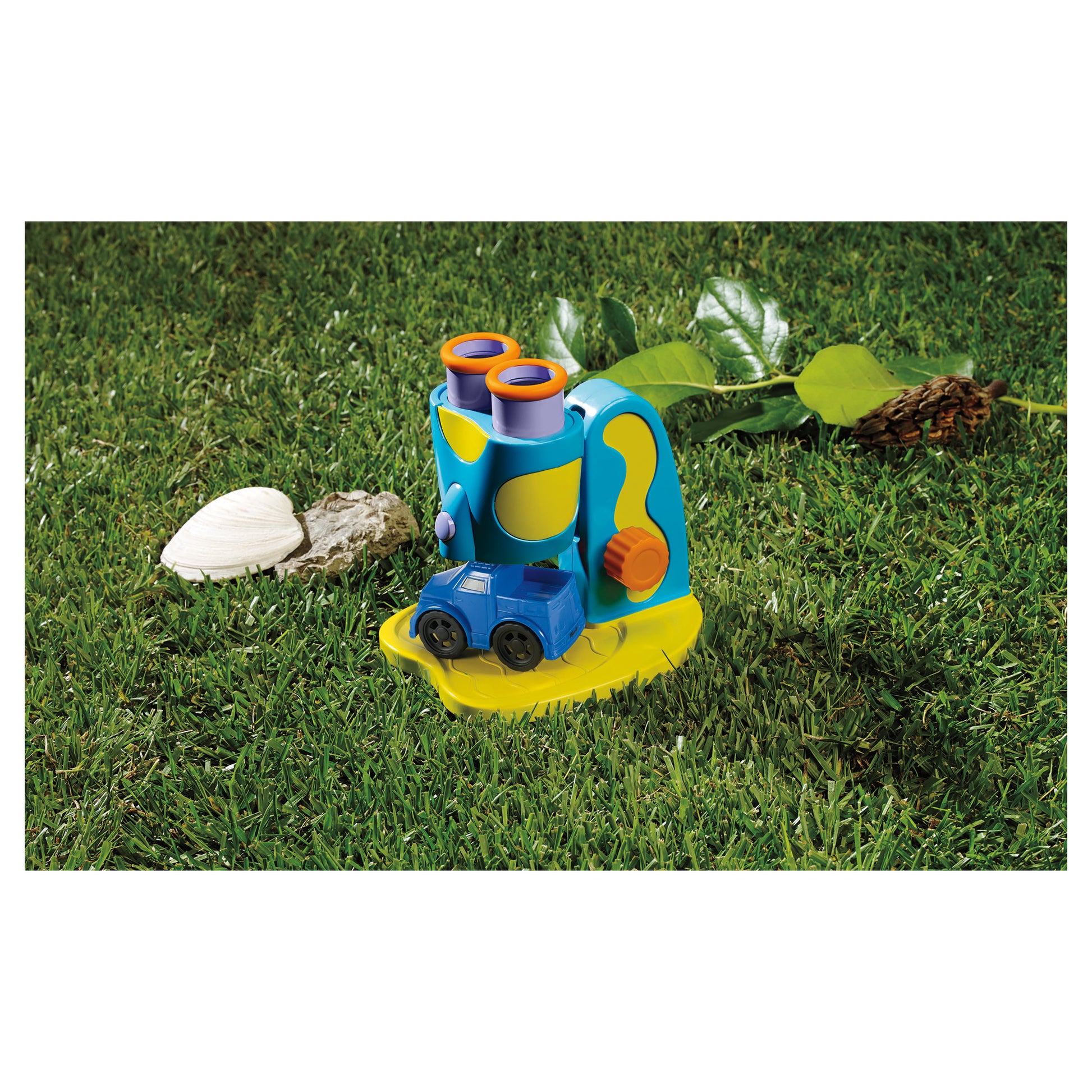 GeoSafari Jr. My First Microscope in blue and yellow on grass with shells