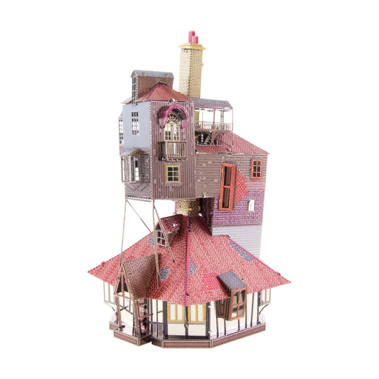 Detailed 3D metal model of The Burrow from Harry Potter, showing a multi-level house with pink and red roofs, wooden siding, towers, windows, and brick chimney