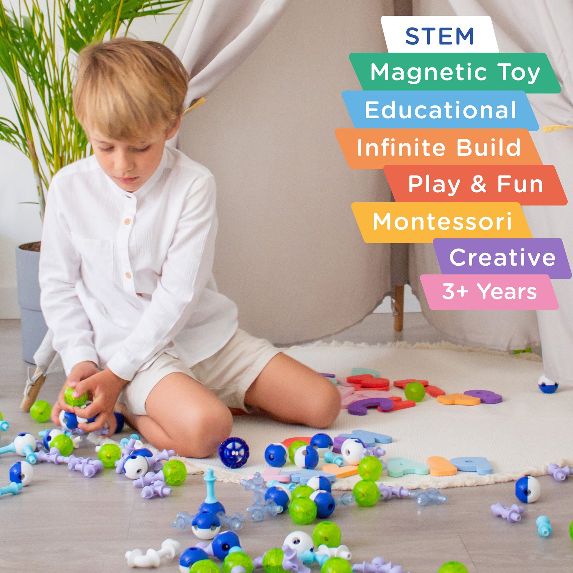 KUB Planet Magnetic Building Set with colorful neon blocks in blue, green, and purple being played with by a toddler